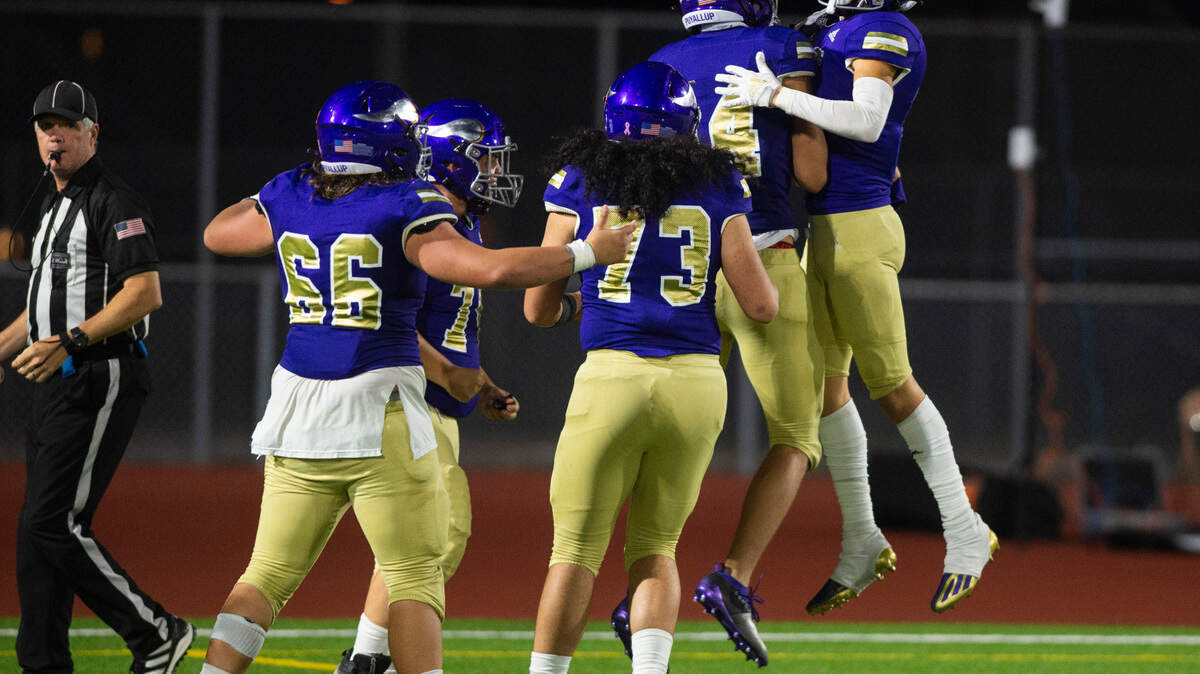 Puyallup wide receiver Kai Richardson (14) celebrates with Puyallup wide receiver Dane Parker (4) after scoring a touchdown in the third quarter of a game against Olympia at Sparks Stadium in Puyallup, Wash. on Oct. 6, 2022. Puyallup defeated Olympia 29-24.
