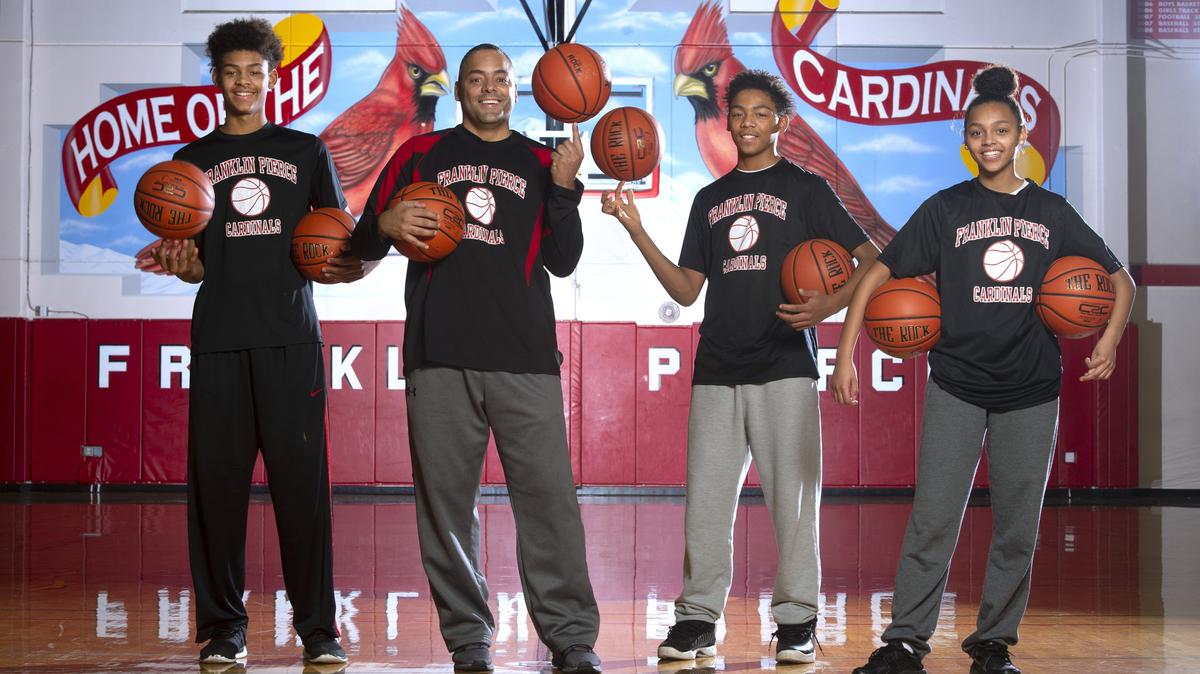 Franklin Pierce boys basketball head coach John Barbee with sophomore son Jalen Barbee (left) and freshman twins John Barbee Jr. and Zionna Barbee at Franklin Pierce High School in Tacoma on Thursday, Jan. 17, 2019.