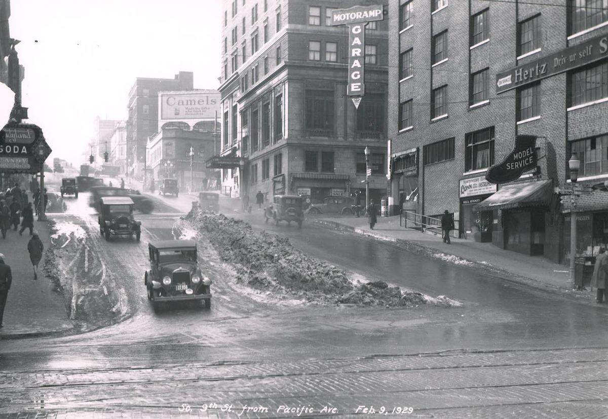 Street scene showing snow/slush on South Ninth Street looking up from Pacific Avenue in February, 1929. Motoramp Garage (745 Commerce Street) is on right, with a musical instrument shop on the ground level.