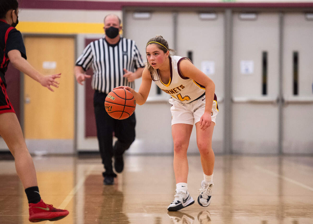 White River Hornet’s guard Lexie Banks (14) watches Sammamish Totems’s guard Isabella Bass (5) as she brings the ball down the court during the high school girls basketball state tournament regional round game at Mount Tahoma High School in Tacoma, Wash. on Friday, Feb. 25, 2022.