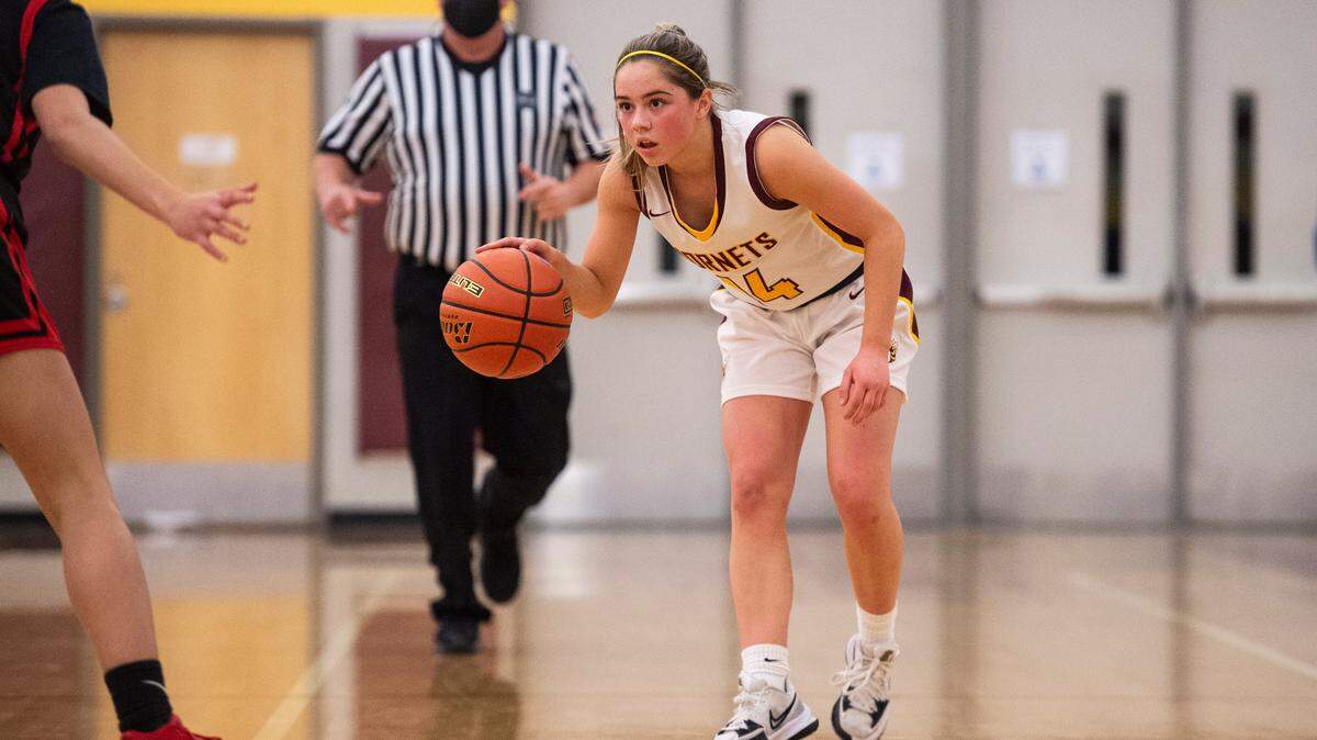 White River Hornet’s guard Lexie Banks (14) watches Sammamish Totems’s guard Isabella Bass (5) as she brings the ball down the court during the high school girls basketball state tournament regional round game at Mount Tahoma High School in Tacoma, Wash. on Friday, Feb. 25, 2022.