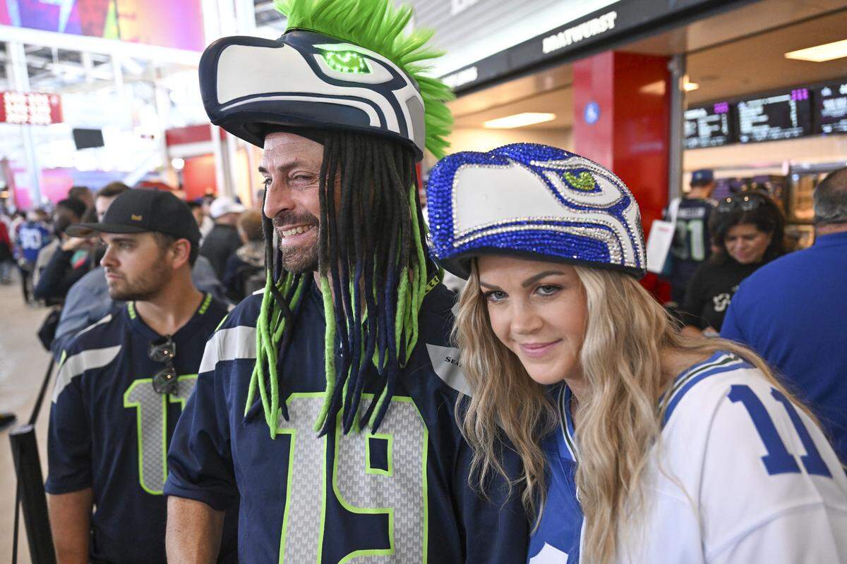 Seattle Seahawks fans Brent Campbell and Chynna Campbell show off their Seahawks hats before the start of Super Bowl LX at Levi’s Stadium in Santa Clara on Sunday, Feb. 8, 2026.
