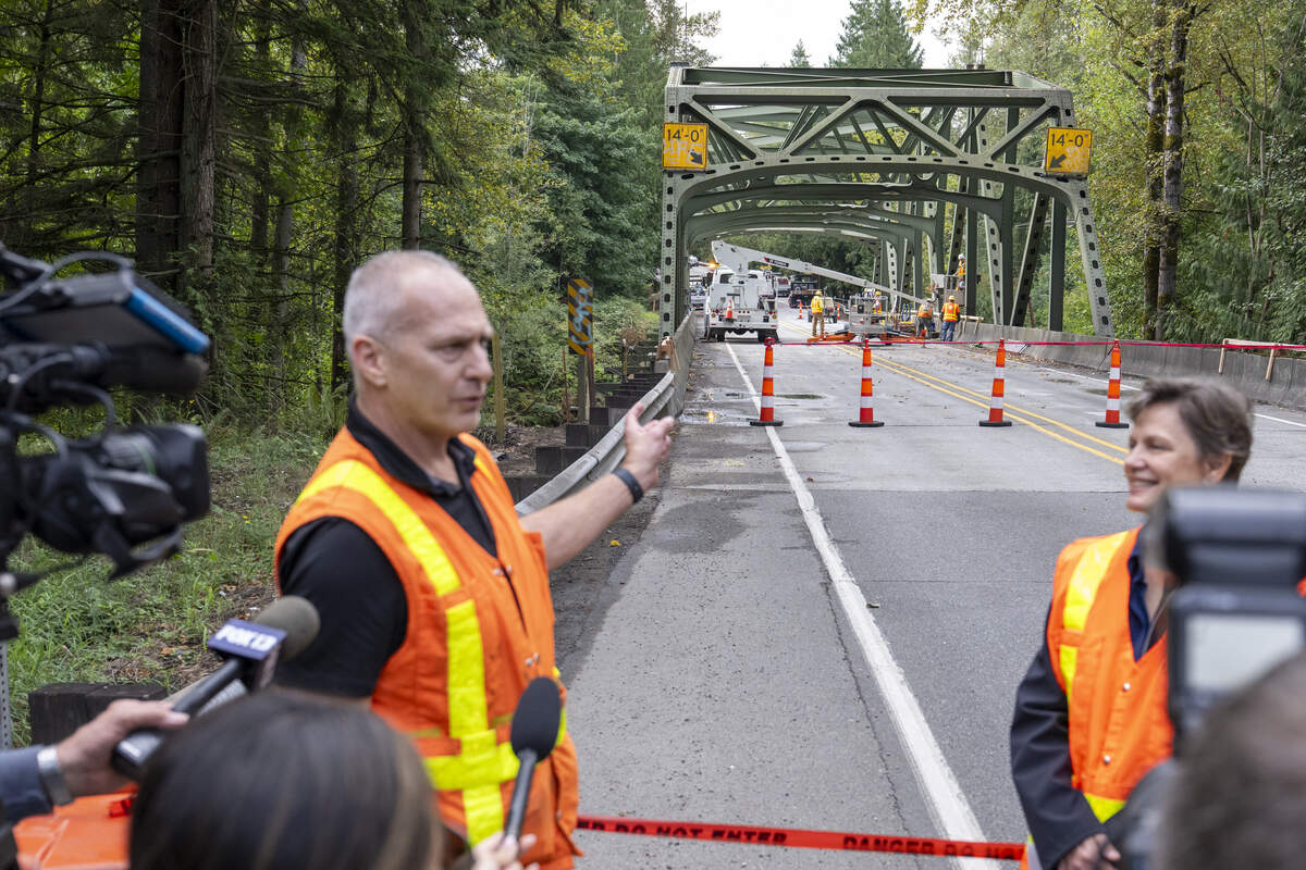Geoff Swett, left, a bridge designer and steel specialist working on the White River Bridge repairs, points out work plans to repair the bridge on Monday, Sept. 8, 2025, in Enumclaw, Wash.