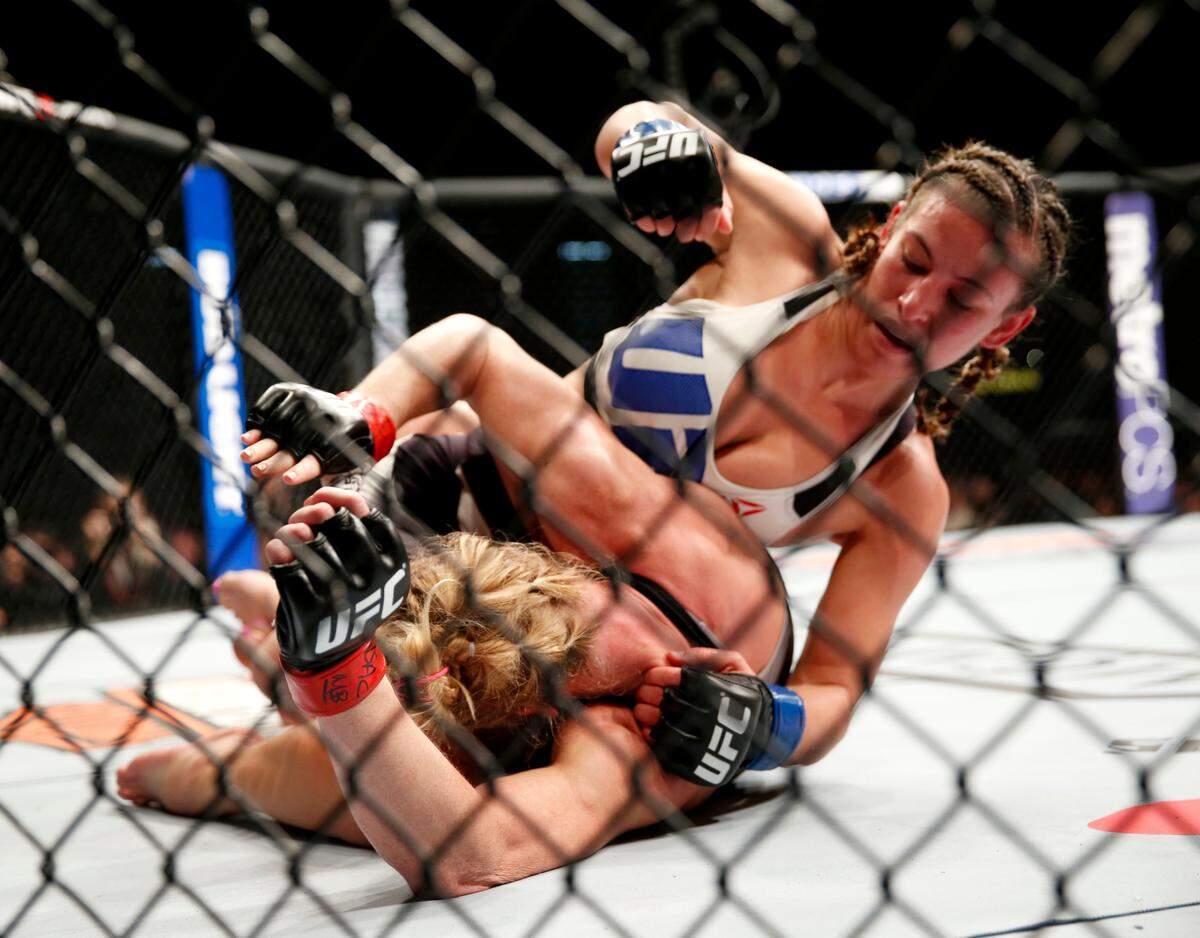 FILE - In this March 5, 2016, file photo, Miesha Tate, right, dominates Holly Holm during their UFC 196 women’s bantamweight mixed martial arts match in Las Vegas. Holly Holm is already the answer to a trivia question as the first fighter to dominate and defeat Ronda Rousey. Holm’s championship reign lasted only four months, and another loss soon followed that left Holm not as the heir apparent to Rousey in the women’s division, but rather on the cusp of being labeled an MMA version of a one-hit wonder like Buster Douglas.(AP Photo/Eric Jamison, File)