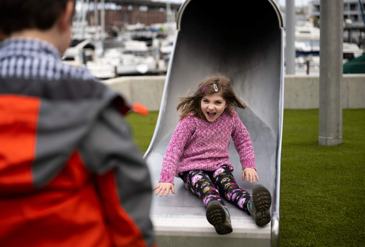 Maren Snow, 6, comes down the slide as her brother Eli, 7, waits for her at Melanie’s Park, on Wednesday, April 3, 2024, in Tacoma, Wash.