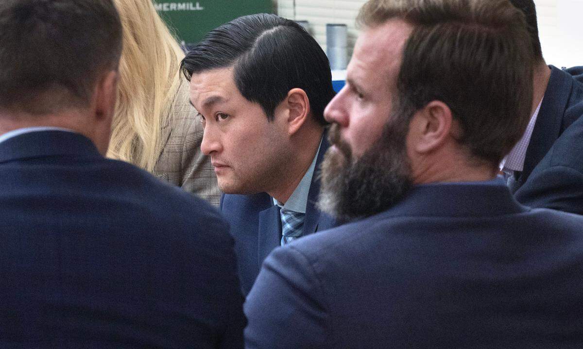 Tacoma police officers Timothy Rankine (center) and Matthew Collins (right) in Pierce County Superior Court in Tacoma, Wash., on Wednesday, Dec. 20, 2023. (Tony Overman / Pool Photo - The News Tribune)
