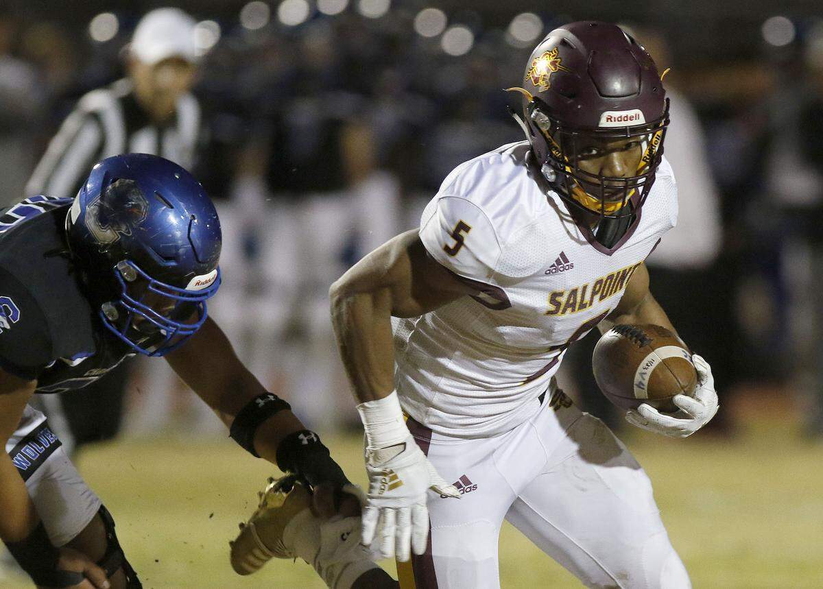 Salpointe High School’s Bijan Robinson (5) turns the corner on Chandler’s defense during their Open Division semifinal game on Saturday, Nov. 23, 2019 in Chandler, Ariz.