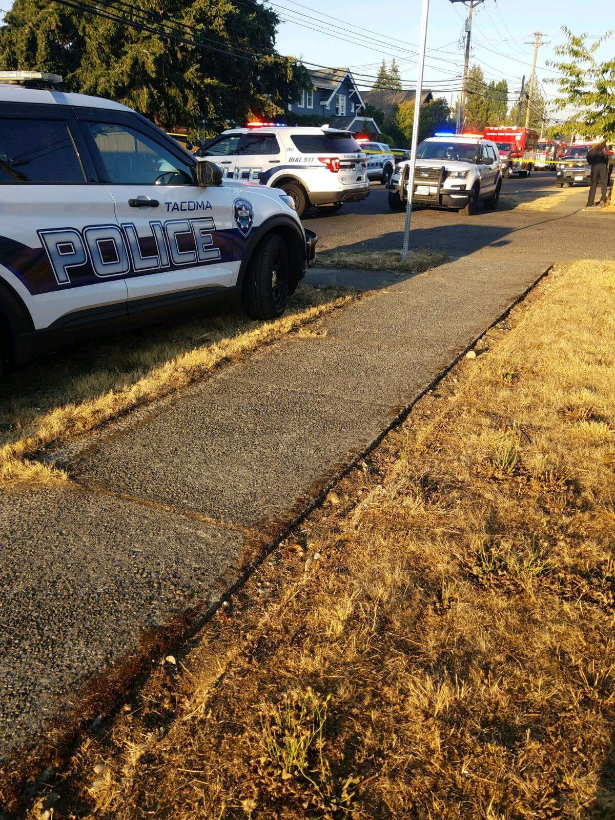 Responders from the Tacoma police and fire departments block off the 3600 block of South 31st Street. Nicholaus Ahlstrand, 44, of Tacoma, was shot and killed in the area on Aug. 9, 2022.