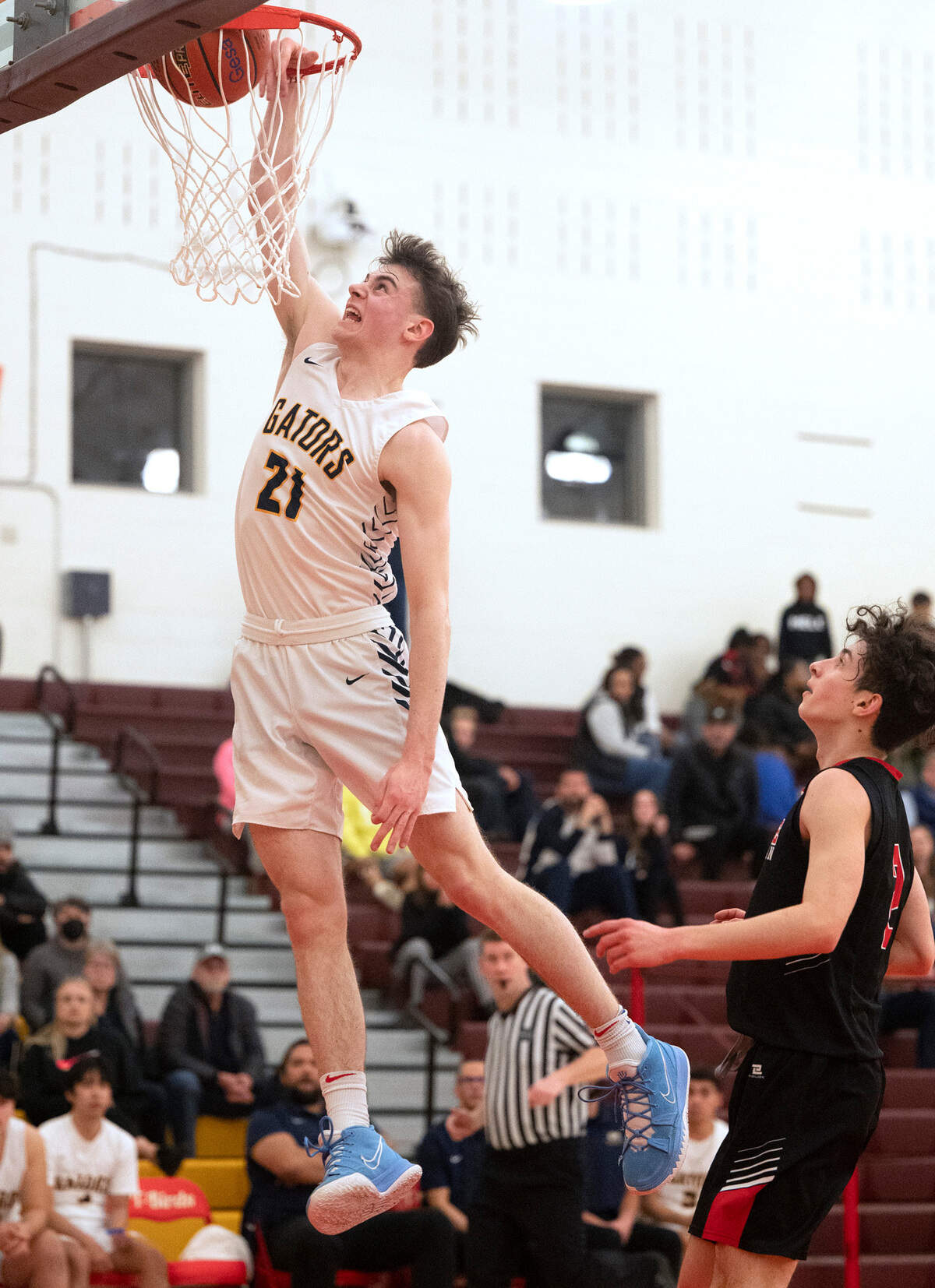 Annie Wright’s Martin Kaupanger rises for a breakaway dunk in front of Seattle Christian defender Eric Lyubarksy during the 1A West Central District boys basketball championship game at Mount Tahoma High School in Tacoma, Washington, on Wednesday, Feb. 15, 2023. Annie Wright battled from behind, then held off multiple Warrior runs to win, 65-60.