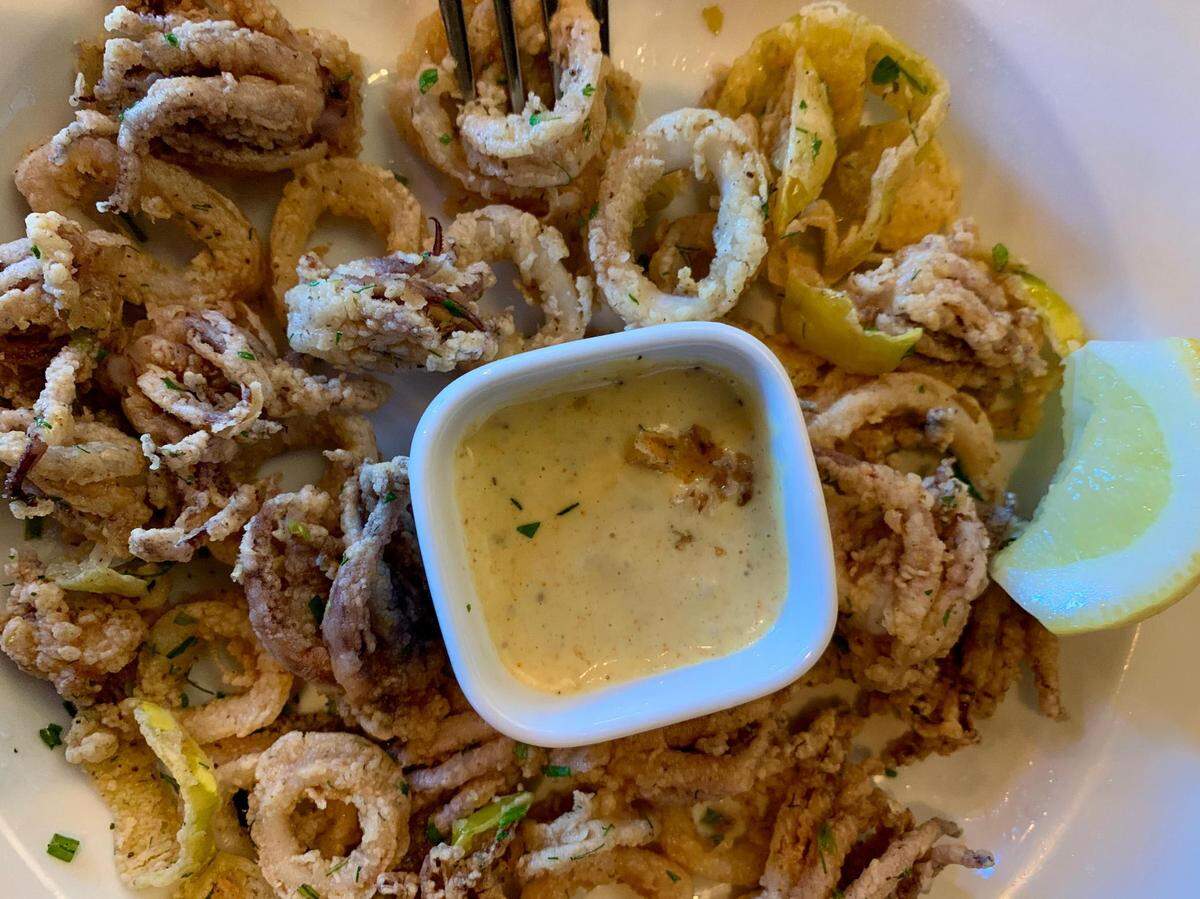 The calamari was so addictive that the writer snapped this photo after digging in -- see a piece that fell into the aioli!