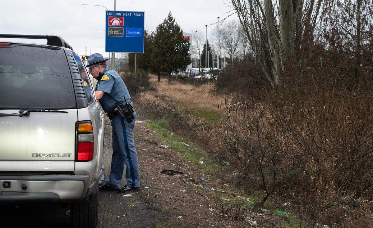 Washington State Patrol Trooper Shannon McKenzie talks with a driver accused of using the HOV lane to skip a line of vehicles waiting at an on-ramp light on Interstate 5 through Fife, Washington, on Tuesday, Feb. 27, 2024. McKenzie says the number one complaint WSP receives from the public is about HOV lane violators.