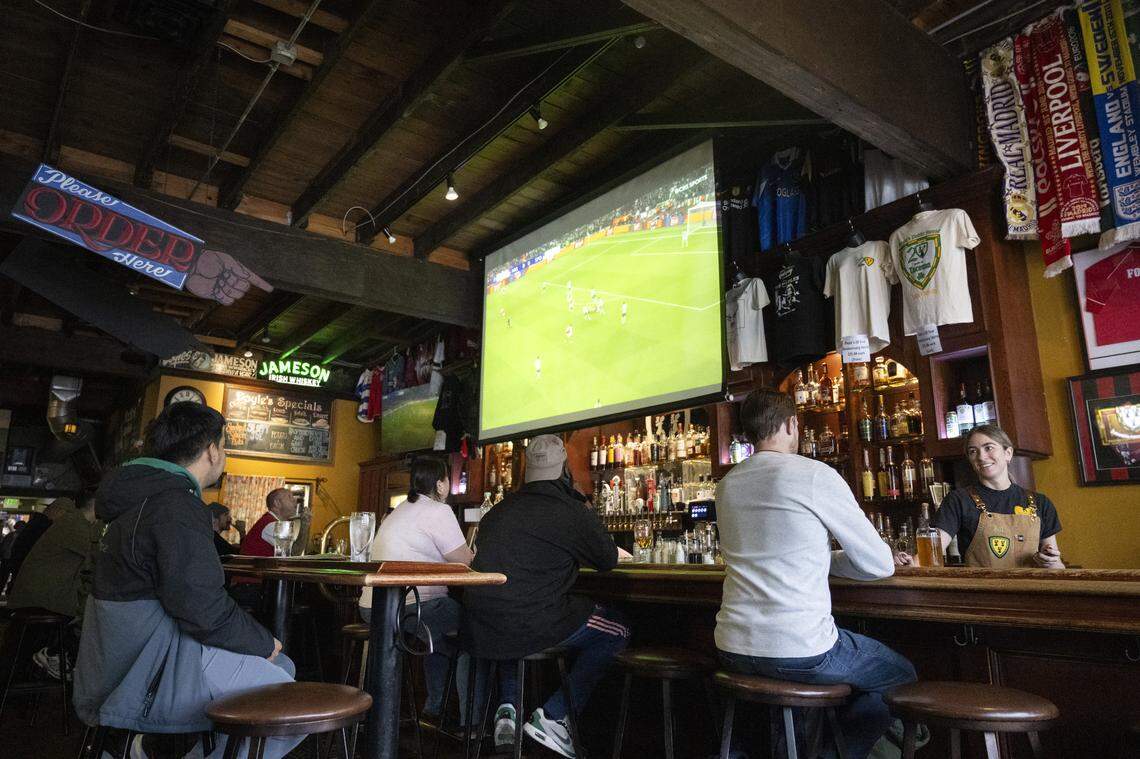 Bartender Jill Donaldson, right, moves between fans as they watch two concurrent Champions League quarterfinals games on April 15. The bar always seems to emanate a warm, fuzzy feeling and is a haven for soccer fans.