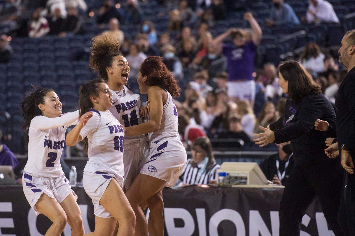Pasco players and coaches celebrate following a win. Pasco beat Lake Stevens, 37-35, in a Class 4A state basketball quarterfinals game on Thursday, March 3, 2022 at the Tacoma Dome in Tacoma, Wash.