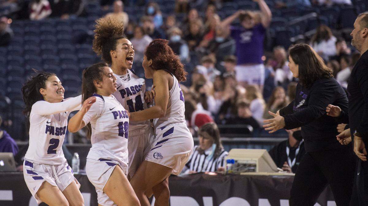 Pasco players and coaches celebrate following a win. Pasco beat Lake Stevens, 37-35, in a Class 4A state basketball quarterfinals game on Thursday, March 3, 2022 at the Tacoma Dome in Tacoma, Wash.