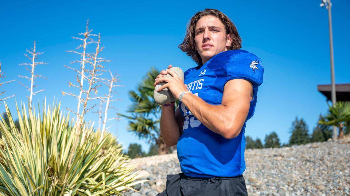 Curtis quarterback Rocco Koch poses for a portrait outside the stadium at Curtis High School on Wednesday, Sept. 7, 2022, in University Place.