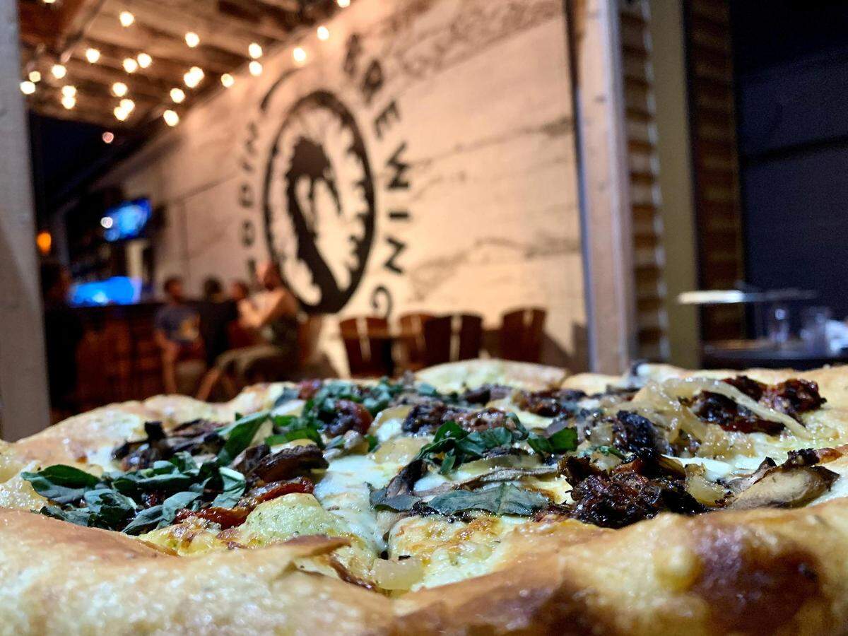 Odin Brewing Tacoma opened in the summer of 2020 in the former home of The Hub. The restaurant has a few tables on a small deck patio and in a converted garage space with bistro lights and exposed wood beams.