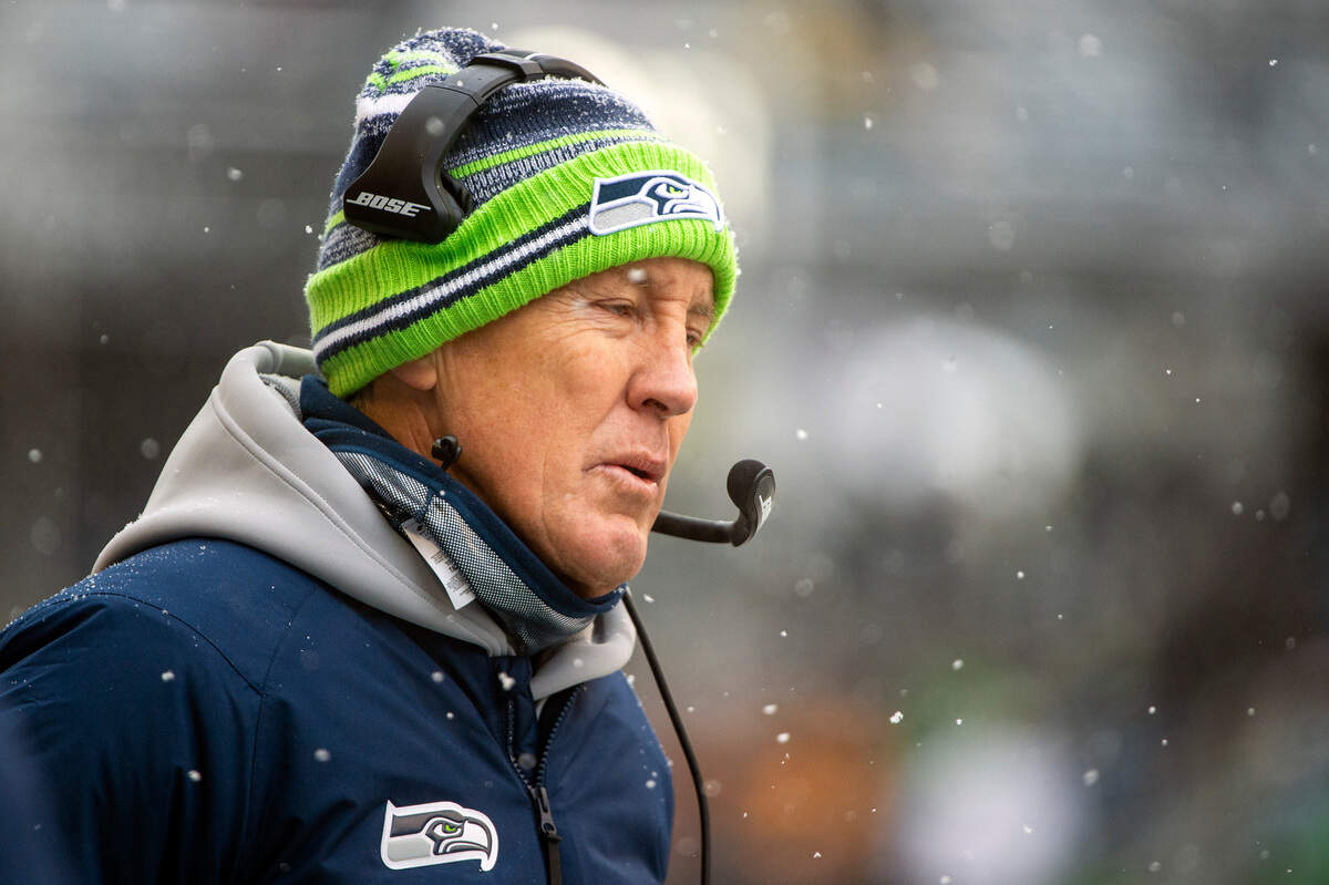 Seattle Seahawks head coach Pete Carroll squints through the falling snow during the second quarter of an NFL game against the Chicago Bears on Sunday afternoon at Lumen Field in Seattle.