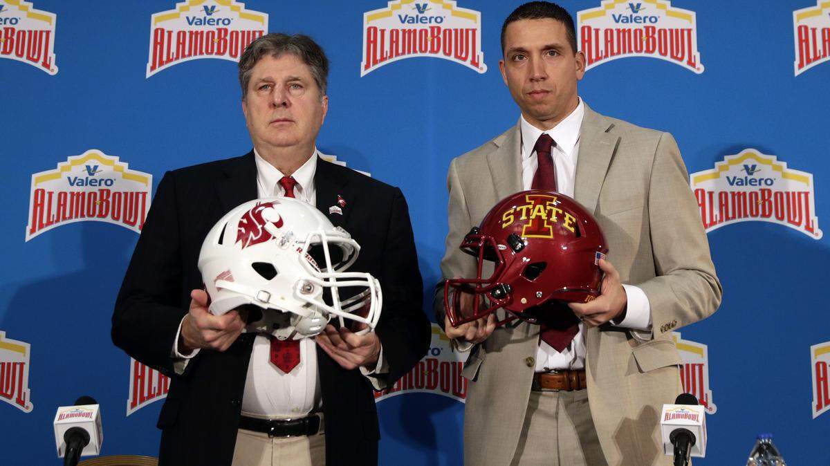 Washington State head coach Mike Leach, left, and Iowa State head coach Matt Campbell, right, pose for a photo following a news conference, Thursday, Dec. 27, 2018, in San Antonio. Washington State and Iowa State are set to play in Friday’s NCAA college football Alamo Bowl. (AP Photo/Eric Gay)