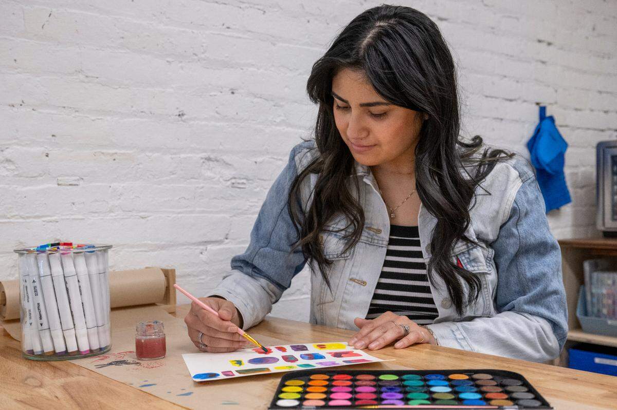 Racquel Fox, owner of Lumikha Space, practices wet-on-wet watercolor painting on Wednesday, May 14, 2025, in anticipation of the shop’s first craft and relax workshop using the same skill on June 1, in Tacoma, Wash.