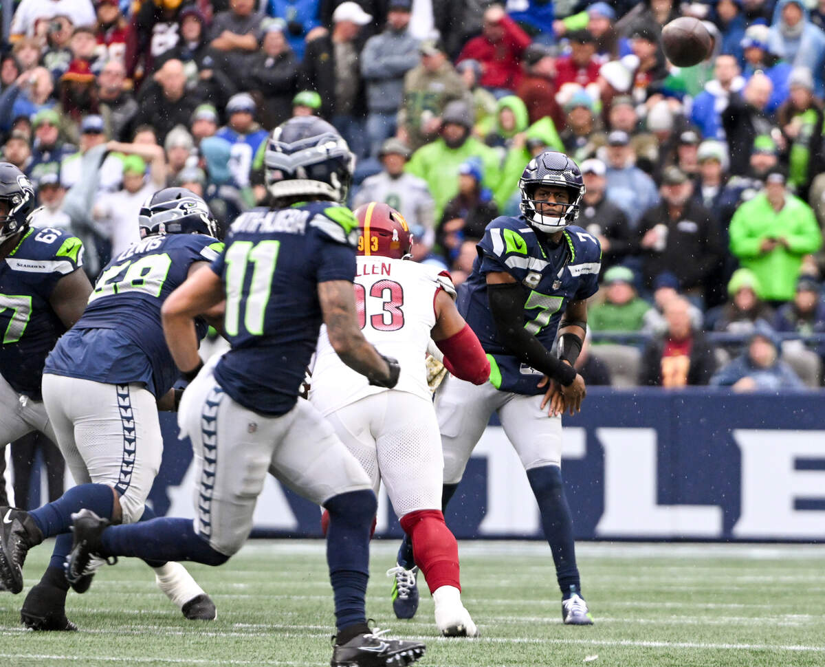 Seattle Seahawks quarterback Geno Smith (7) connects with wide receiver Jaxon Smith-Njigba (11) during the first quarter of the game against the Washington Commanders at Lumen Field, on Sunday, Nov. 12, 2023, in Seattle, Wash.