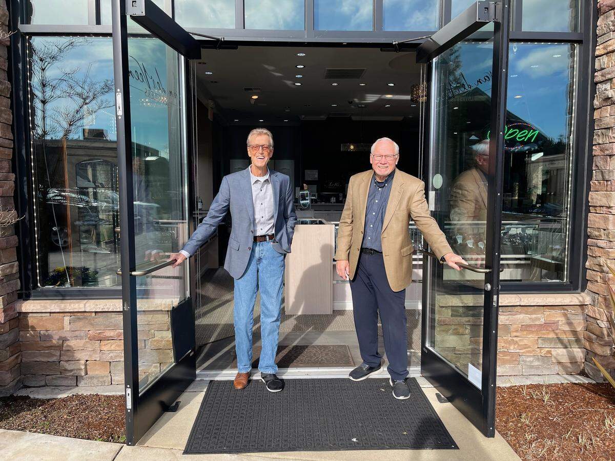 Founder Jann Van der Veen, left, and staff jeweler, David Wakely, right, stand at the entrance to van der Veen Jewelers in Gig Harbor, Wash. in this photo posted to the store’s Facebook Friday, Sept. 9, 2022. The store will close after Dec. 23, 2025.