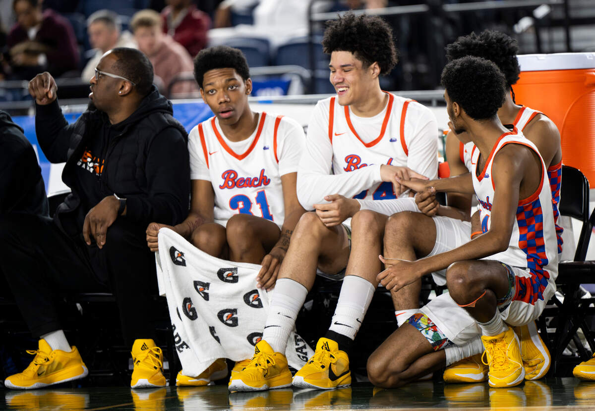 Rainier Beach’s bench celebrates in the closing seconds of the victory over O’Dea during the semifinals game of the Class 4A state tournament at the Tacoma Dome, on Friday, March 1, 2024, in Tacoma, Wash.
