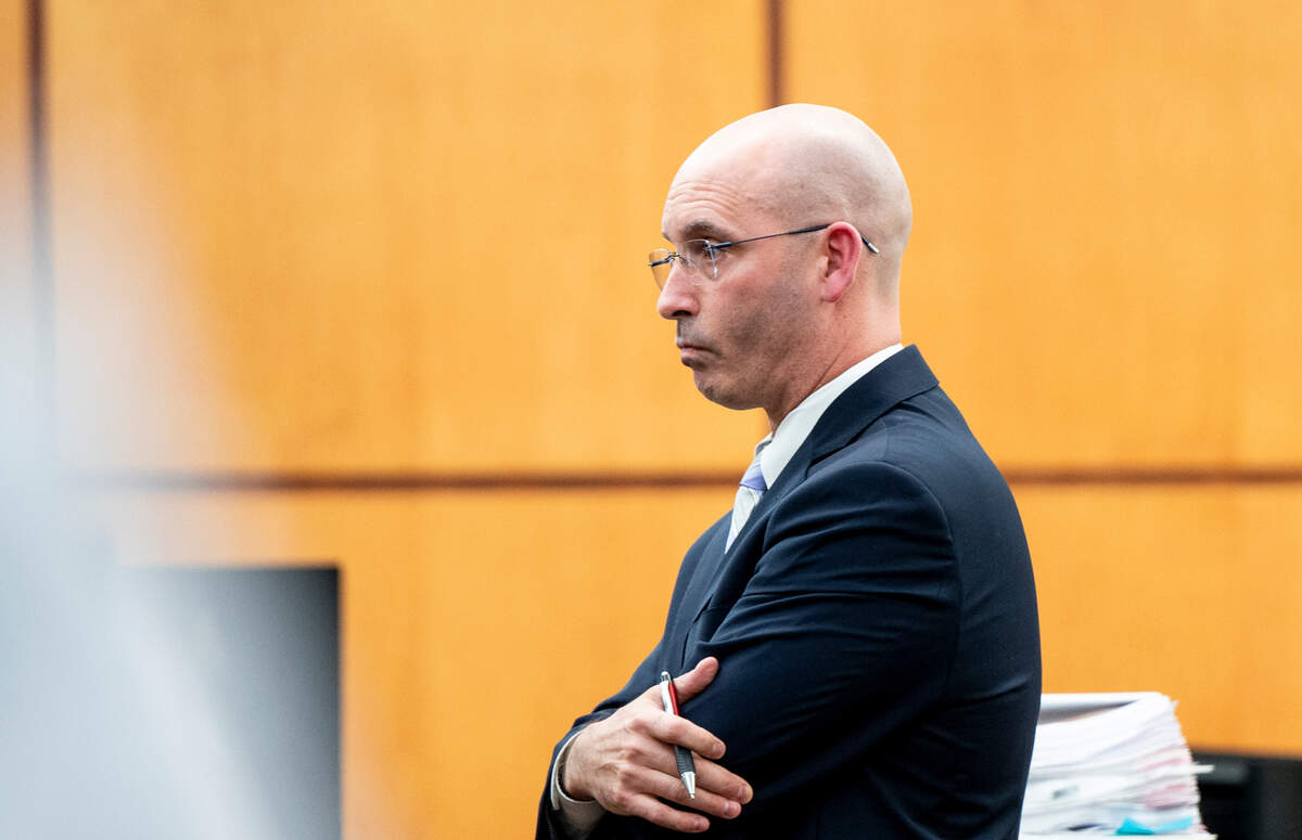 Defense attorney Jared Ausserer cross-examines forensic pathology expert Dr. Roger Mitchell during the trial of three Tacoma Police officers in the killing of Manny Ellis at Pierce County Superior Court, Monday, Oct. 16, 2023, in Tacoma, Wash. Tacoma Police Officers Christopher Burbank, Matthew Collins and Timothy Rankine stand trial for charges related to the March 2020 killing of Manny Ellis. (Brian Hayes / Pool Photo – The News Tribune)