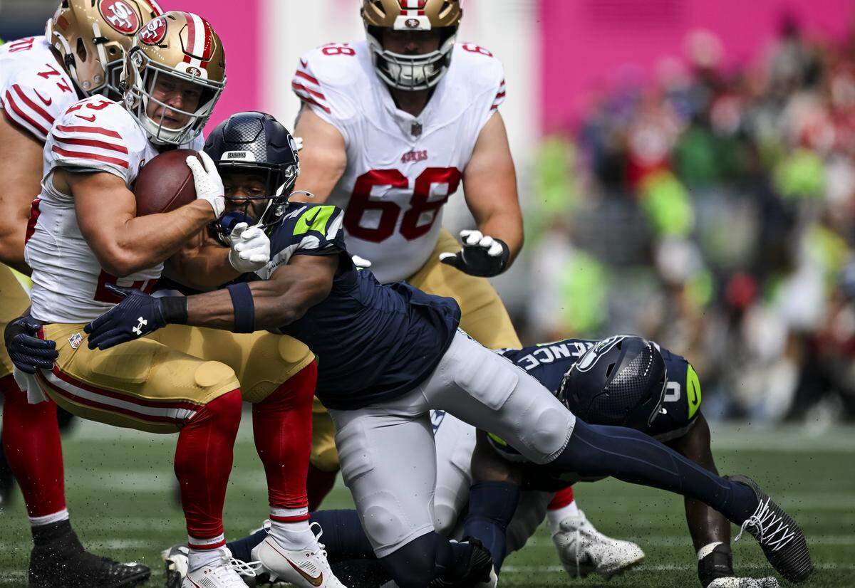 Seattle Seahawks safety Nick Emmanwori (3) tackles San Francisco 49ers running back Christian McCaffrey (23) during the first quarter of the game at Lumen Field, on Sunday, Sept. 7, 2025, in Seattle.