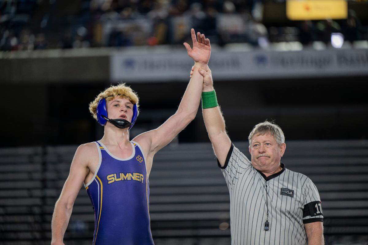 Sumner’s Cody Miller has his hand raised against Olympia’s Landon Porter in the 157-pound 4A championship during day two of the Mat Classic XXXV at the Tacoma Dome on Saturday, Feb. 17, 2024, in Tacoma, Washington.