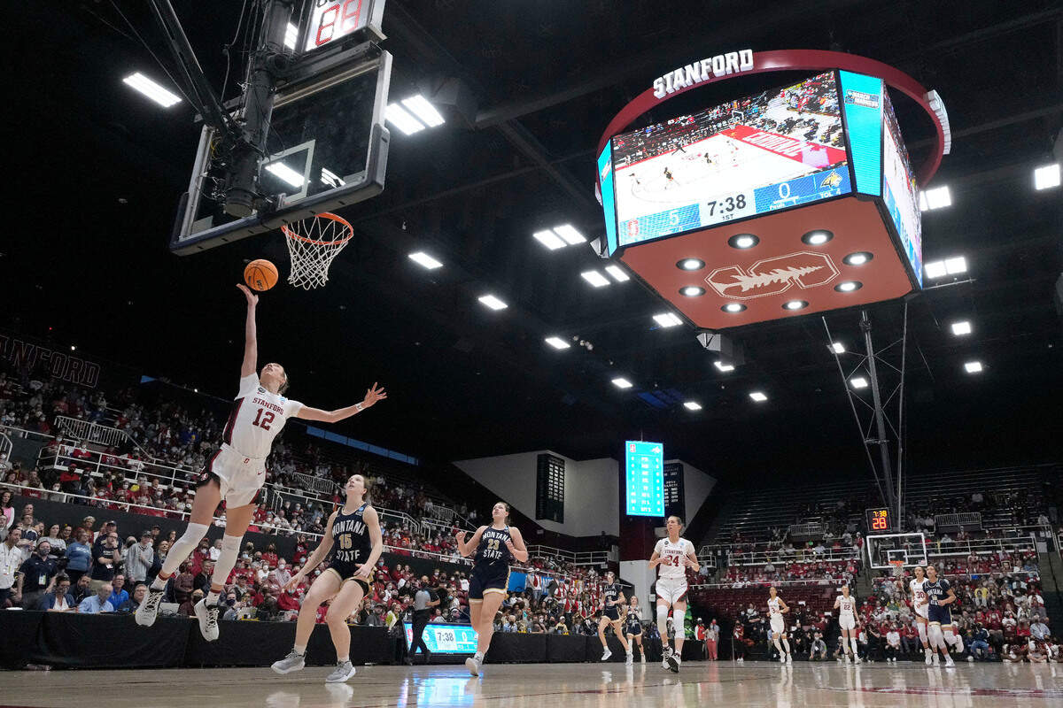 Stanford guard Lexie Hull (12) drives to the basket past Montana State guard Leia Beattie (15) during the first half of a first-round game in the NCAA women’s college basketball tournament Friday, March 18, 2022, in Stanford, Calif. (AP Photo/Tony Avelar)