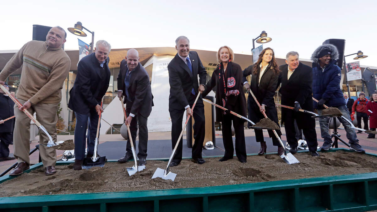 Gov. Jay Inslee, center left, and Seattle Mayor Jenny Durkan, center right, reach for shovelfuls of sand with other officials during a ceremonial groundbreaking of a renovation of the arena at Seattle Center Wednesday, Dec. 5, 2018, in Seattle. The NHL Board of Governors gave final approval to Seattle’s bid to add the hockey league’s 32nd team a day earlier and play is expected to begin at the arena in 2021. (AP Photo/Elaine Thompson)