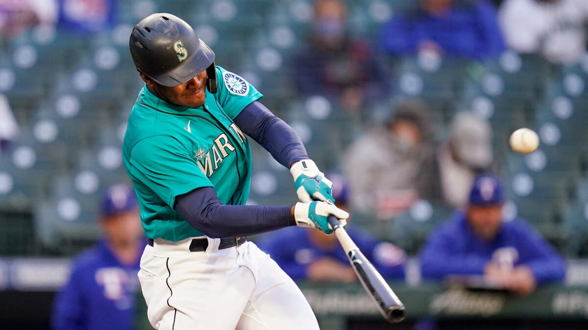 Seattle Mariners’ Kyle Lewis hits a two-run home run against the Texas Rangers during the third inning of a baseball game Friday, May 28, 2021, in Seattle. (AP Photo/Elaine Thompson)