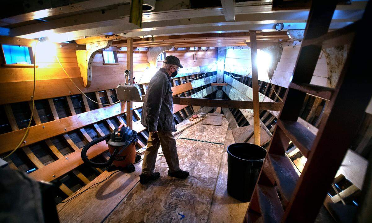 Volunteer Andy Ruotsala below deck of the 65-foot Shenandoah fishing vessel under restoration at the Harbor History Museum in Gig Harbor, Washington, on Thursday, Feb. 3, 2022.
