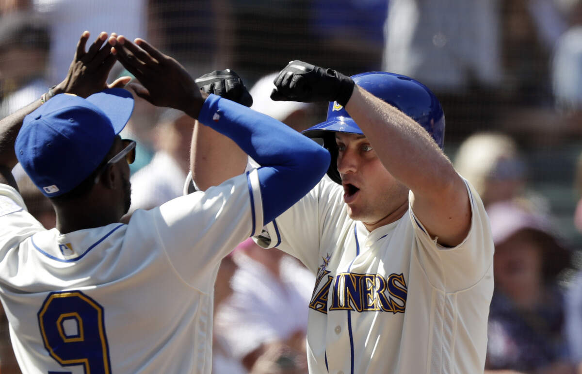 Seattle Mariners’ Kyle Seager, right, is greeted by Dee Gordon after Seager’s home run against the Toronto Blue Jays in the sixth inning of a baseball game Sunday, Aug. 5, 2018, in Seattle. (AP Photo/Elaine Thompson)
