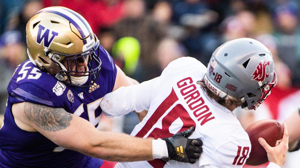 Washington Huskies linebacker Ryan Bowman (55) Washington State Cougars quarterback Anthony Gordon (18) during the second quarter. The Washington Huskies played the Washington State Cougars in the Apple Cup at Husky Stadium in Seattle, Wash., on Friday, Nov. 29, 2019.