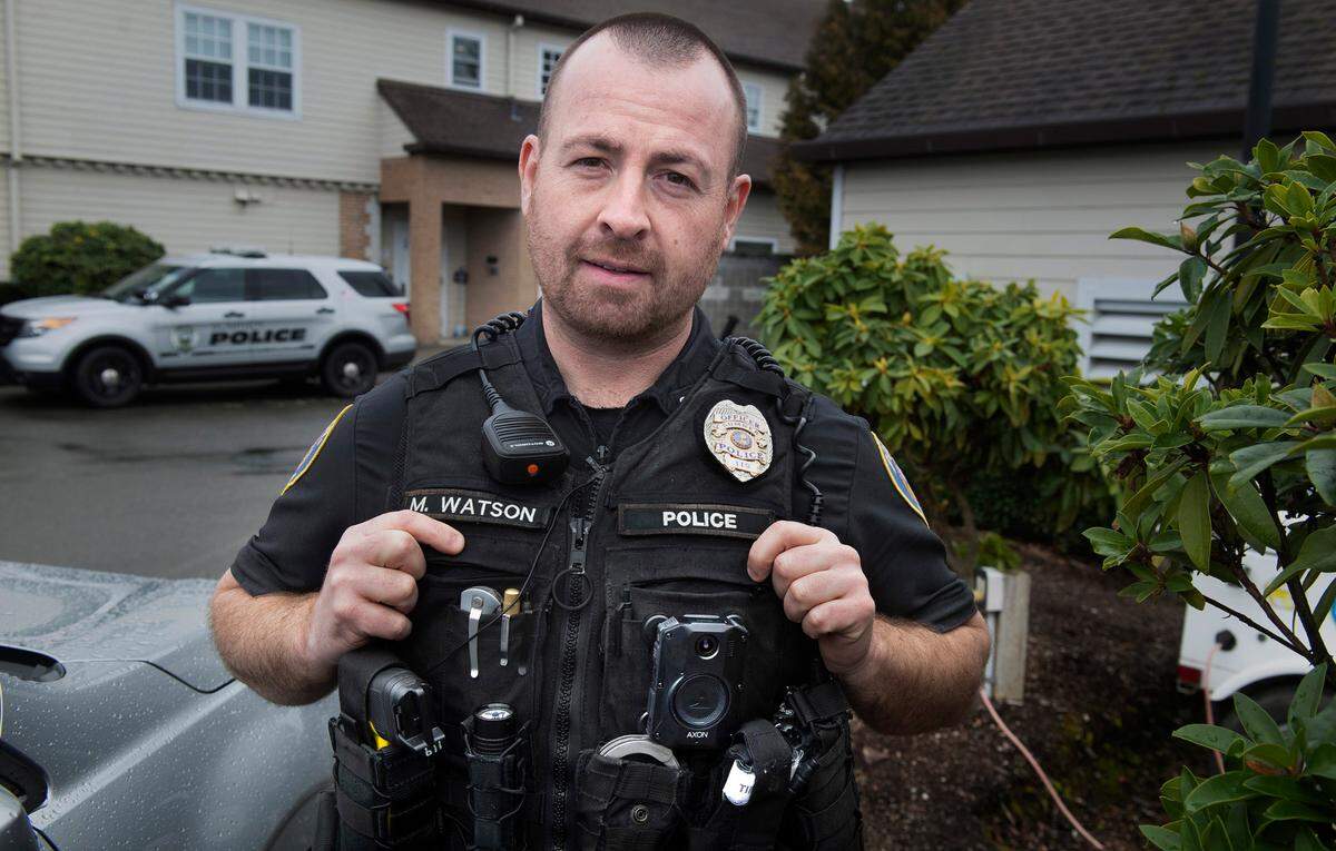 Sumner police officer Matt Watson wears one of the department’s new AXON body cameras outside the Sumner Police Department in Sumner, Washington, on Thursday, Feb. 3, 2022.