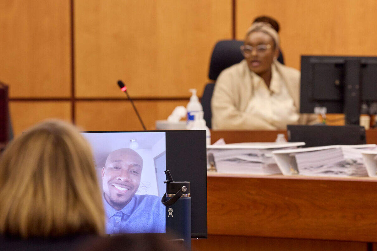 Monet Carter-Mixon, sister of Manny Ellis, testifying during the trial of Tacoma police officers Christopher Burbank, Matthew Collins and Timothy Rankine in Pierce County Superior Court , Thursday, Oct. 5, 2023, in Tacoma. A photo of her brother is seen in the foreground.