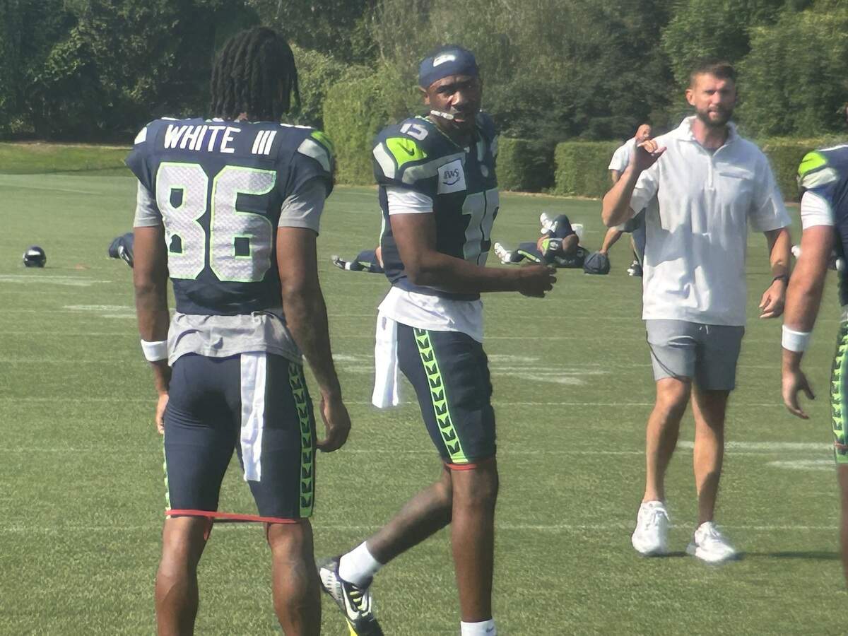 Tory Horton (15) talks to fellow rookie wide receiver and Seattle draft pick Ricky White during the eighth practice of Seattle Seahawks NFL training camp Thursday, July 31, 2025 at the Virginia Mason Athletic Center in Renton.
