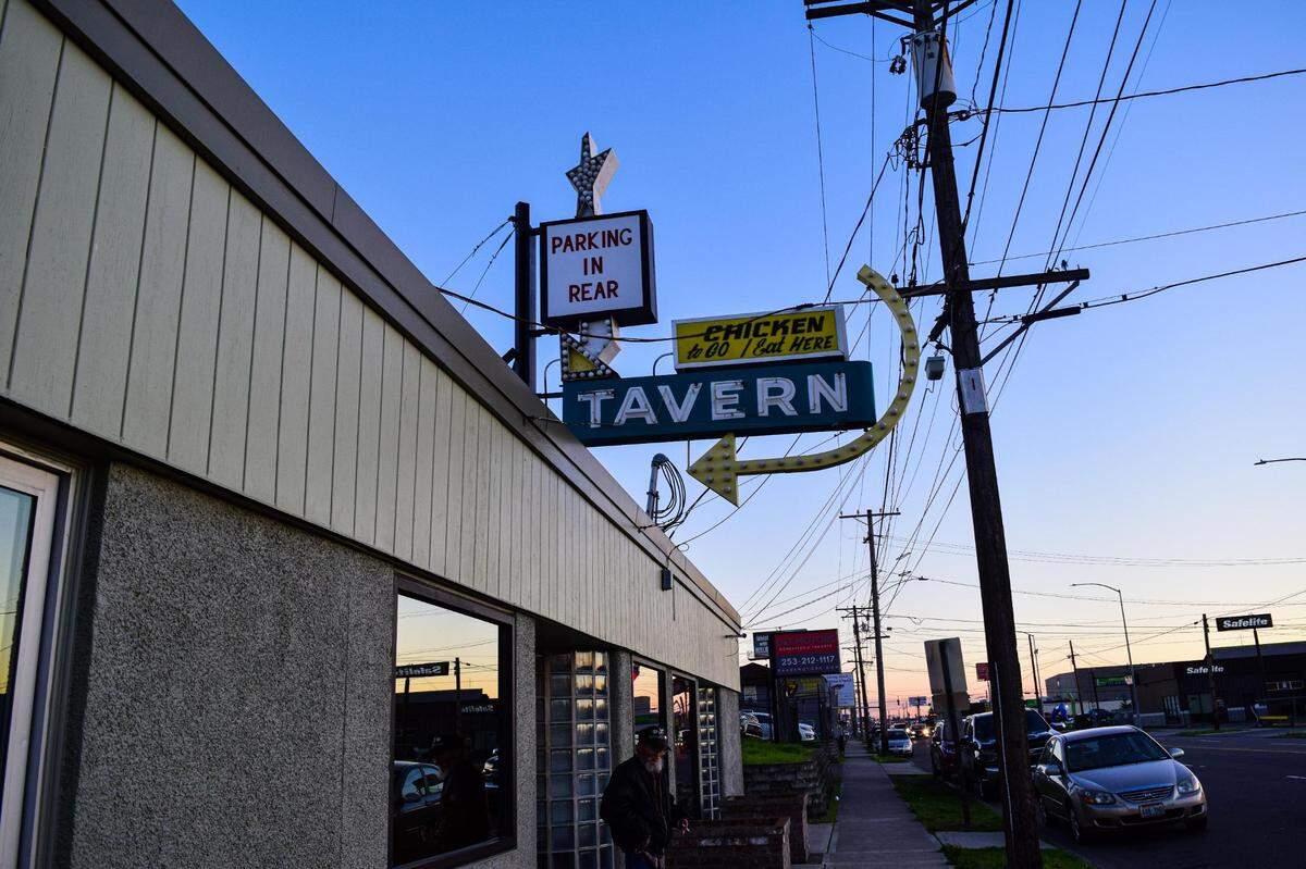 The vintage TAVERN and CHICKEN to-go / EAT HERE sign almost fell off the building once, Peterson recalled. A city grant helped her offset the cost of modernizing it with current bulbs, shown here at sunset on Friday, Oct. 27, 2023.