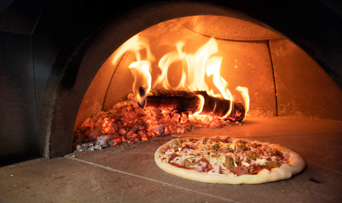 A pizza in the oven at Melissa and Samuel Ranz’s “Just a Pizza My Mind” wood-fired pizza truck at Fierce County Cider in Puyallup, Washington, on Friday, Dec. 16, 2022.