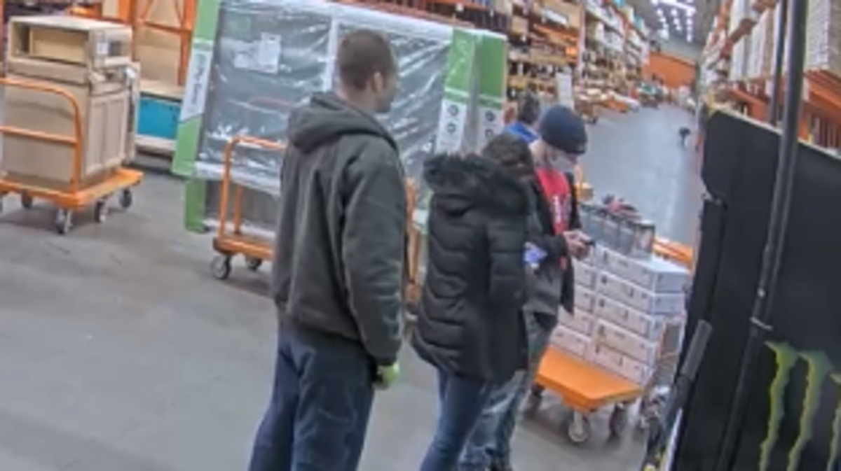 An image from surveillance video obtained by Pierce County Sheriff’s Department shows three people deputies suspect of being involved in an identity-theft ring. The suspects allegedly used a stolen credit card to buy $6,215 worth of merchandise from this store.