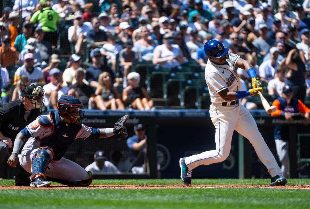 Seattle Mariners designated hitter Kyle Lewis (1) hits the ball during fourth inning of the game at T-Mobile Park on Sunday, July 24, 2022 in Seattle, Wash. The Astros defeated the Mariners 8-5.