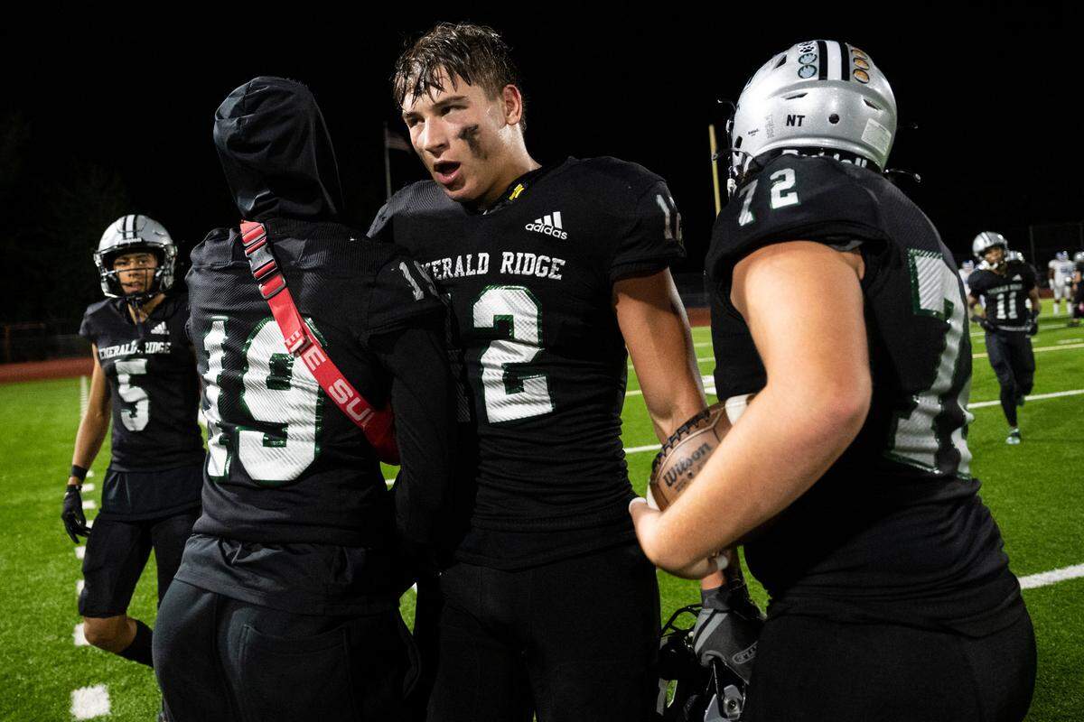 Emerald Ridge tight end Jacob Lane (12) comes off the field after scoring a touchdown by intercepting a pass thrown by Curtis quarterback Rocco Koch (15) in the third quarter of a game at Sparks Stadium in Puyallup, Wash. on Sept. 22, 2022. Emerald Ridge defeated Curtis 42-13.