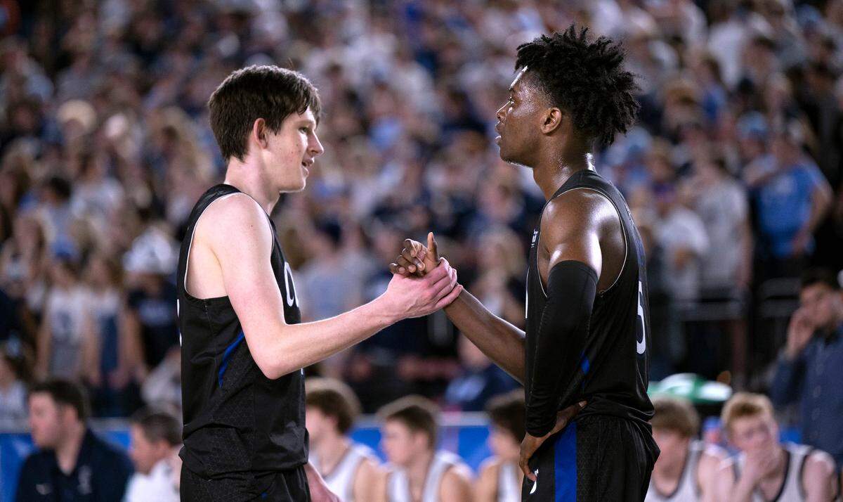 Curtis’ Tyce Paulsen and Zoom Diallo congratulate one another late in the 4A boys state title game against the Olympia Bears at the WIAA state basketball tournament in the Tacoma Dome in Tacoma, Washington, on Saturday, March 4, 2023. Curtis won the game, 49-43.