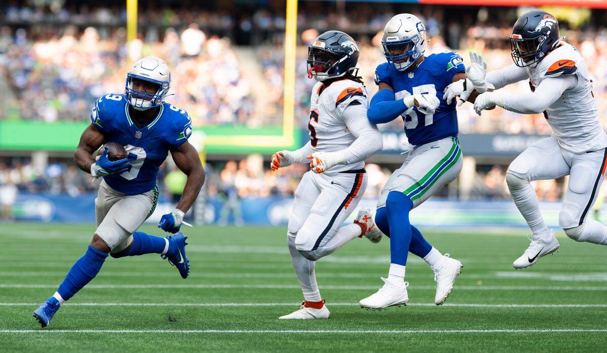 Seattle Seahawks running back Kenneth Walker III (9) runs into the end zone a touchdown that will be called back on a offensive holding call on wide receiver DK Metcalf (14) during the third quarter of the game at Lumen Field, on Sunday, Sept. 8, 2024, in Seattle, Wash.