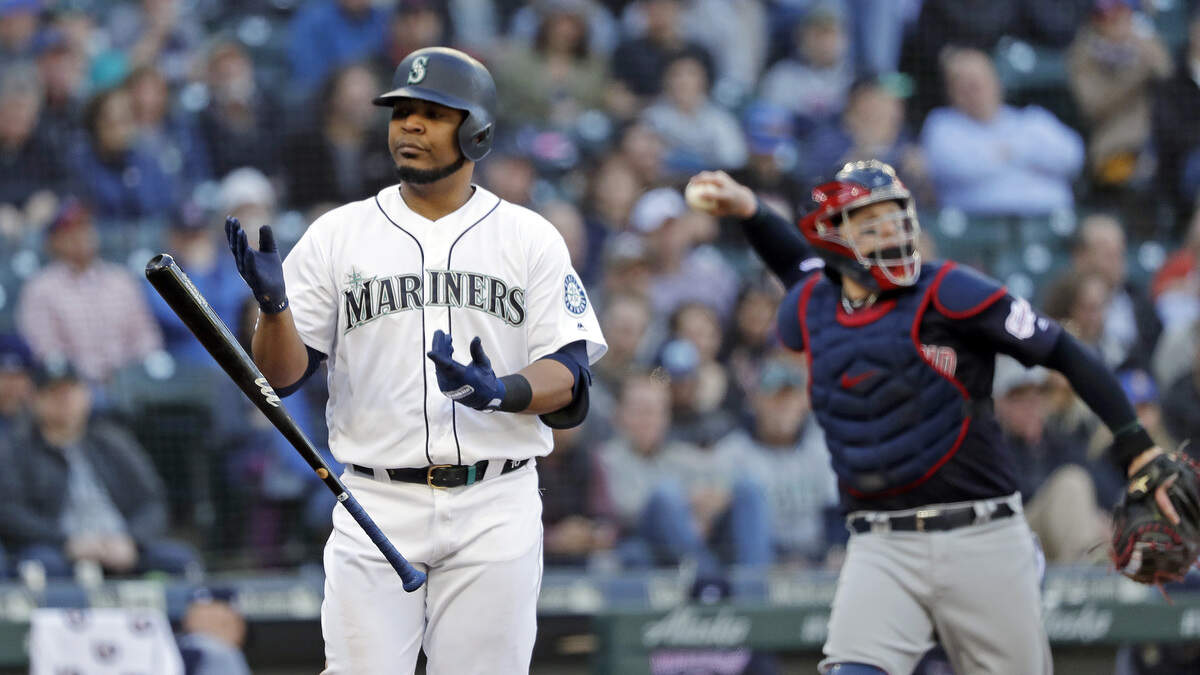 Cleveland Indians catcher Roberto Perez tosses the ball back toward the mound as Seattle Mariners’ Edwin Encarnacion tosses aside his bat after striking out swinging in the fourth inning of a baseball game Wednesday, April 17, 2019, in Seattle. (AP Photo/Elaine Thompson)