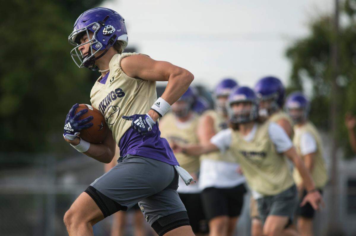 Puyallup High School defensive back Dane Parker runs into the end zone following an interception during a drill at practice on Friday, Aug. 19, 2022 at Sparks Stadium in Puyallup, Wash.