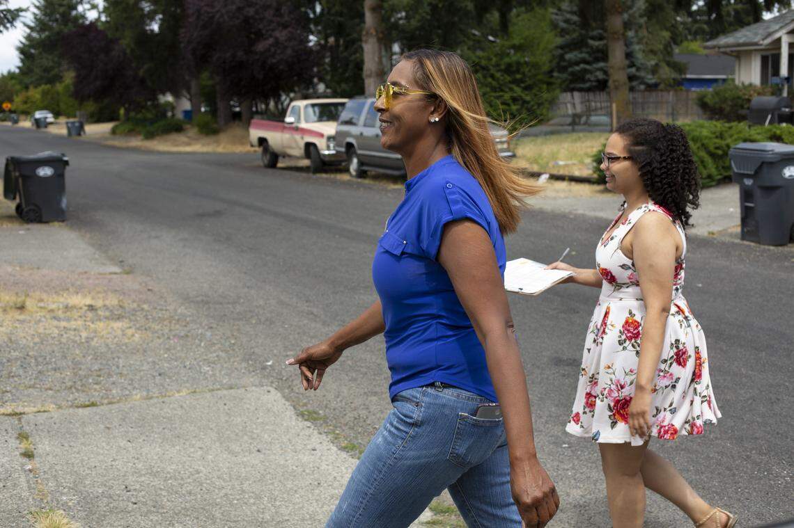 From left, candidate Melanie Morgan and campaign manager Barbara Gilchrist knock on the doors of voters in Spanaway, Wash., July 19, 2018.