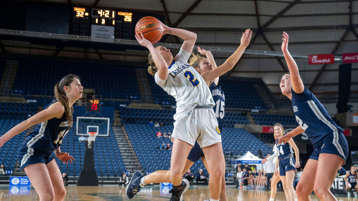 Tahoma guard Hope Hassmann (2) drives in for a layup between a trio of Gonzaga Prep defenders during the third quarter of a Class 4A quarterfinal game on Thursday, March 2, 2023, in Tacoma, Wash.