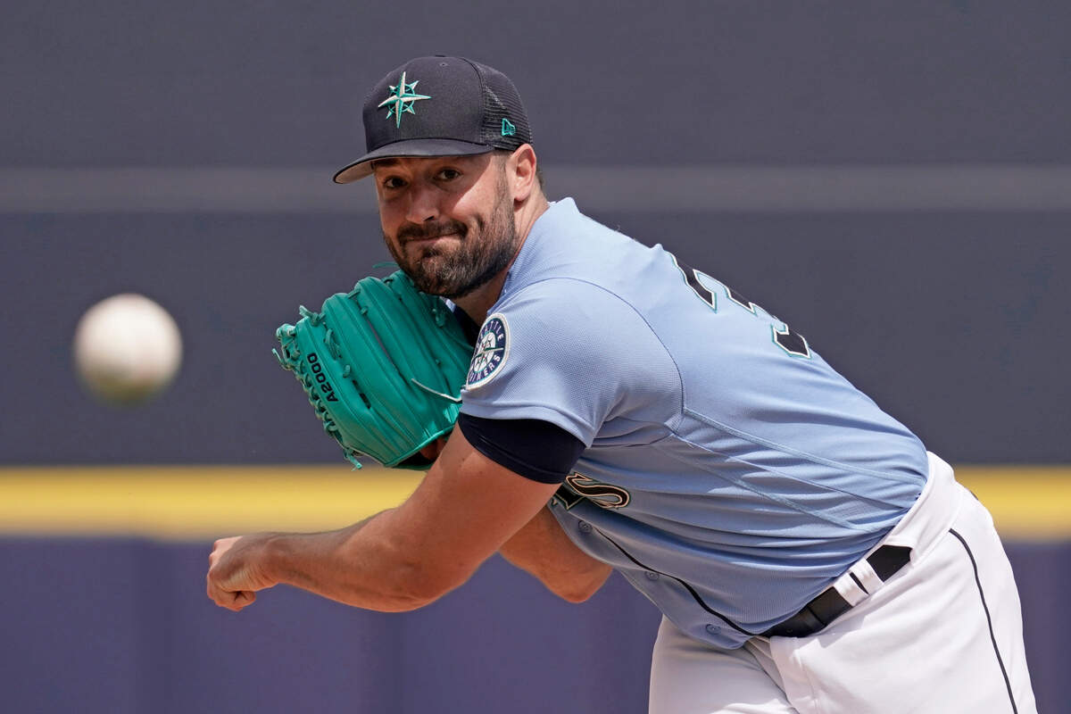 Seattle Mariners starting pitcher Robbie Ray throws during the first inning of a spring training baseball game against the Texas Rangers Monday, March 28, 2022, in Peoria, Ariz. (AP Photo/Charlie Riedel)